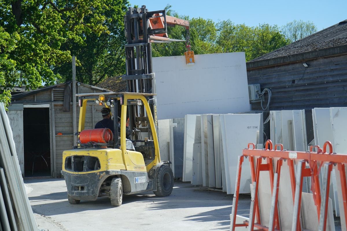 Forklift moving stone slabs at the workshop